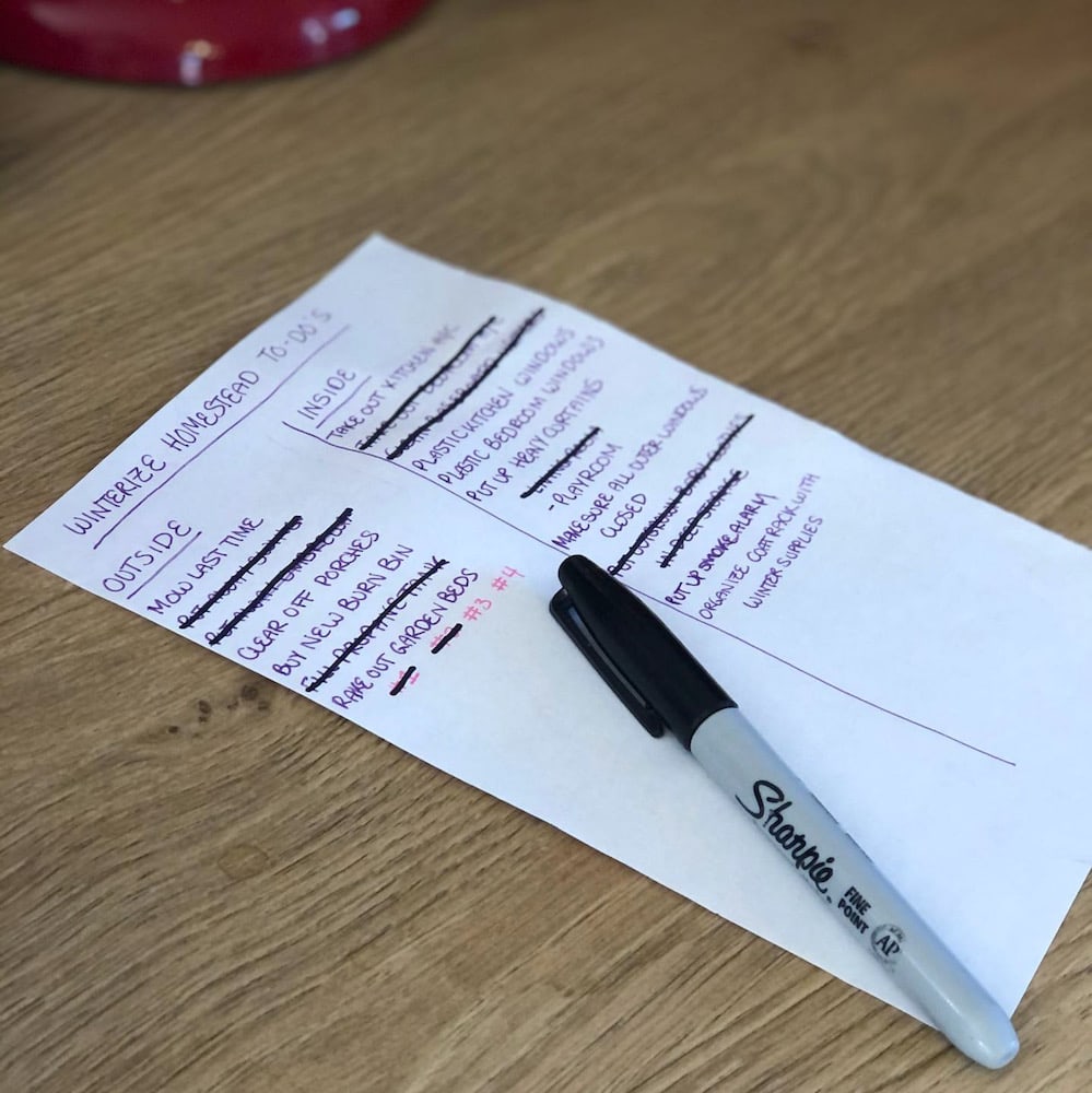 autumn checklist written on paper with wood background