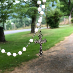 rosary beads in front of a country background
