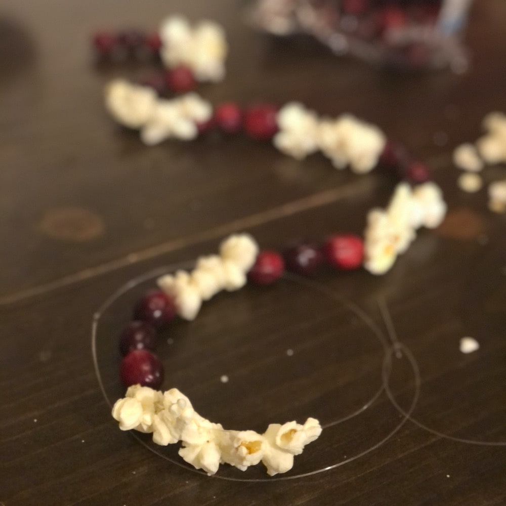 old-fashioned christmas stringing popcorn and cranberries
