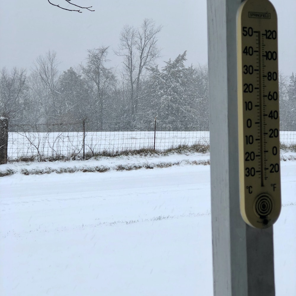 winter snowfall view from porch with thermometer