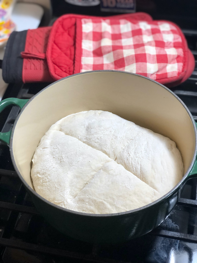 bread dough placed into dutch oven, ready to put in oven to bake