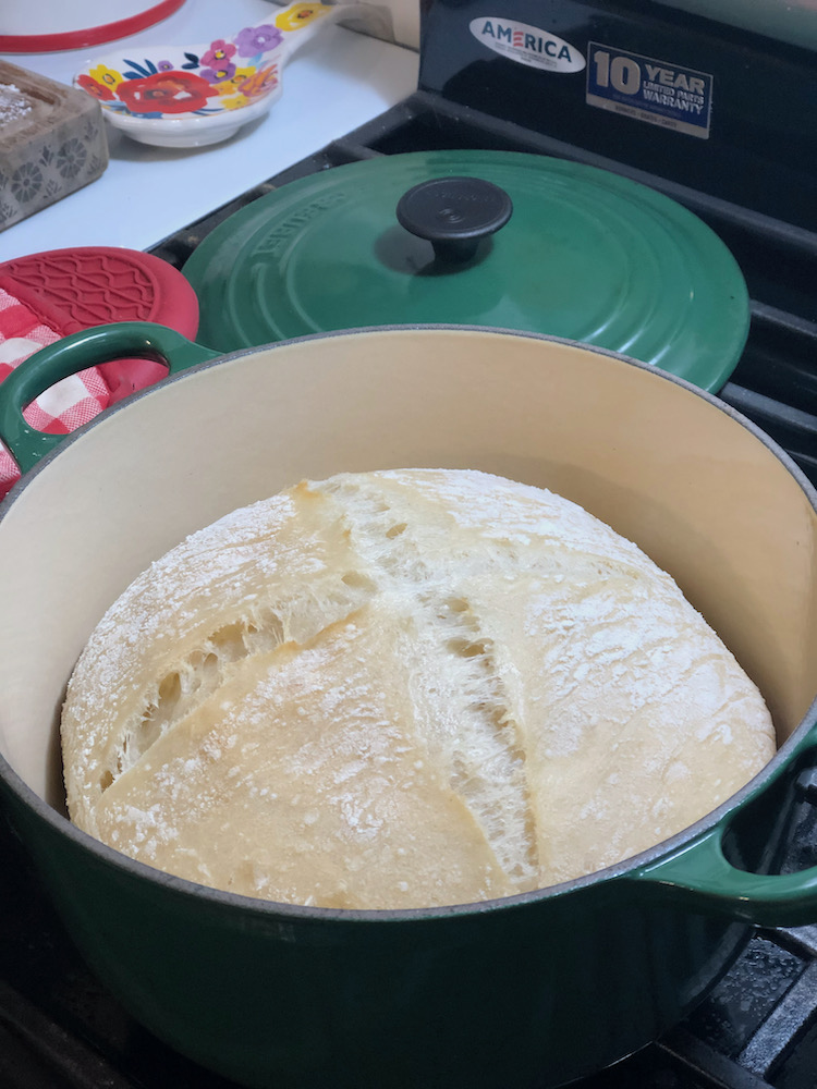 bread dough in the process of baking in dutch oven